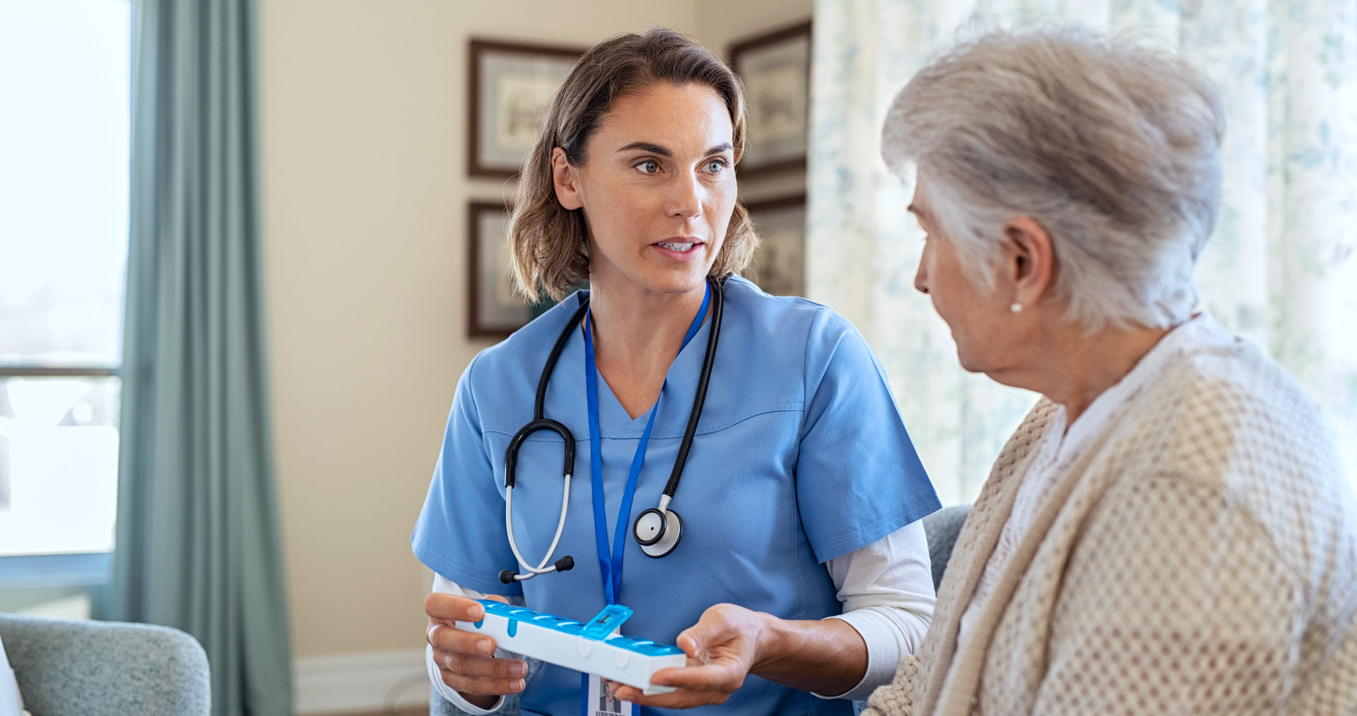 nurse talking with her senior patient